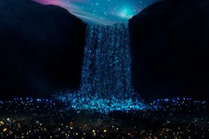 A night scene with a glowing blue waterfall and illuminated particles under a starry sky.